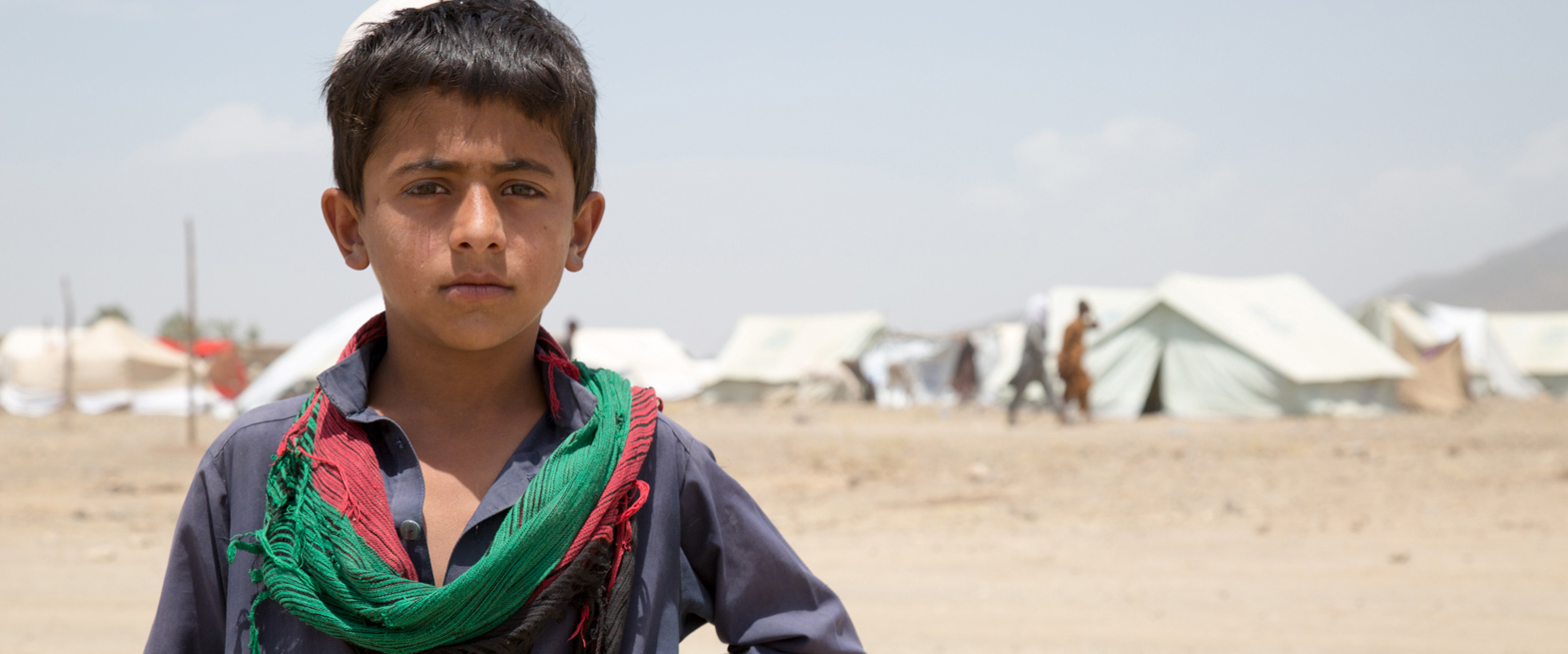 Jongen in Afghaans vluchtelingenkamp. | Foto: Matthew Graydon | IOM, 2014