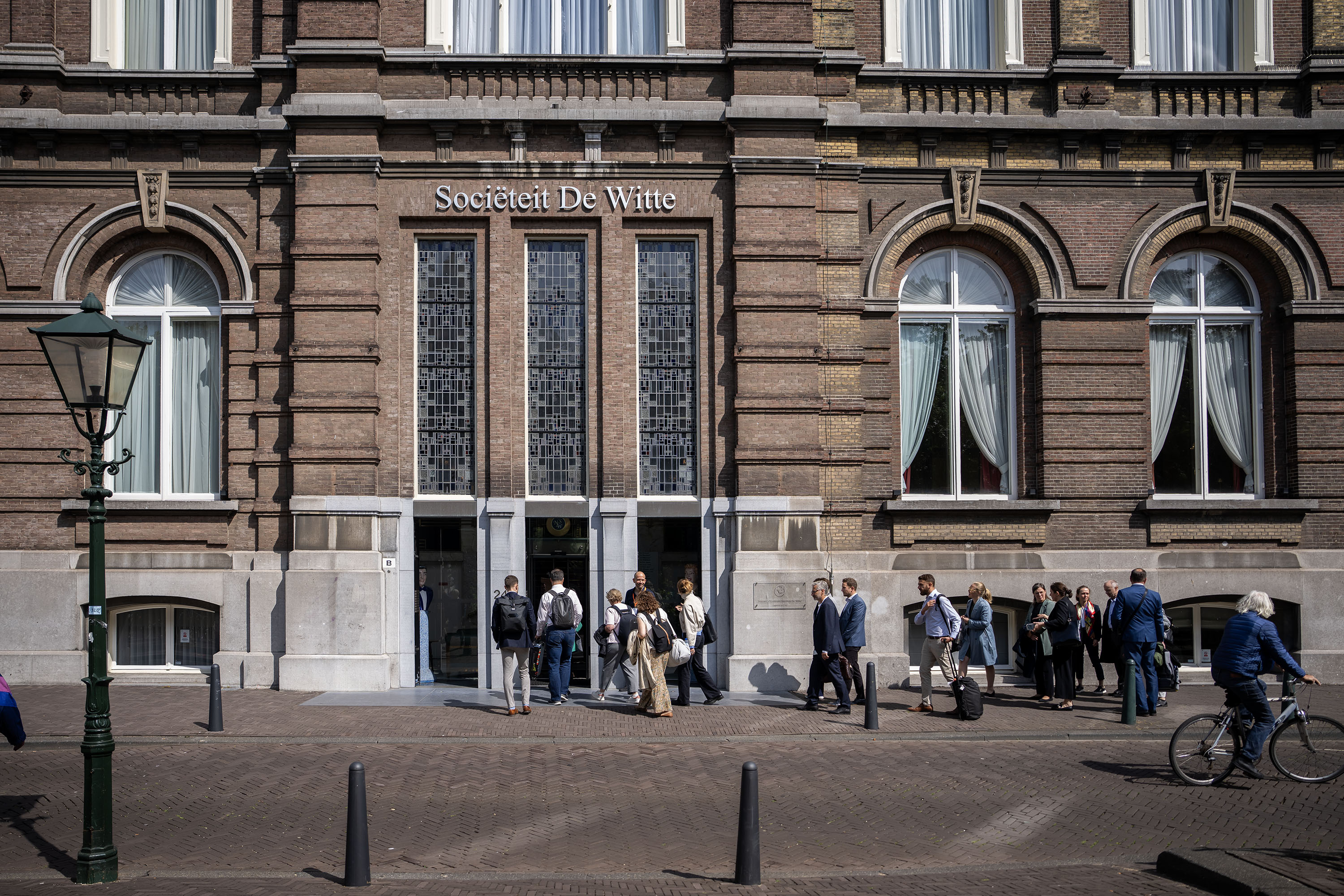 Particpants entering the conference location in The Hague