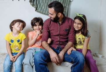 Syrische vader met zijn dochters. |  Foto: Muse Mohammed | IOM, 2016